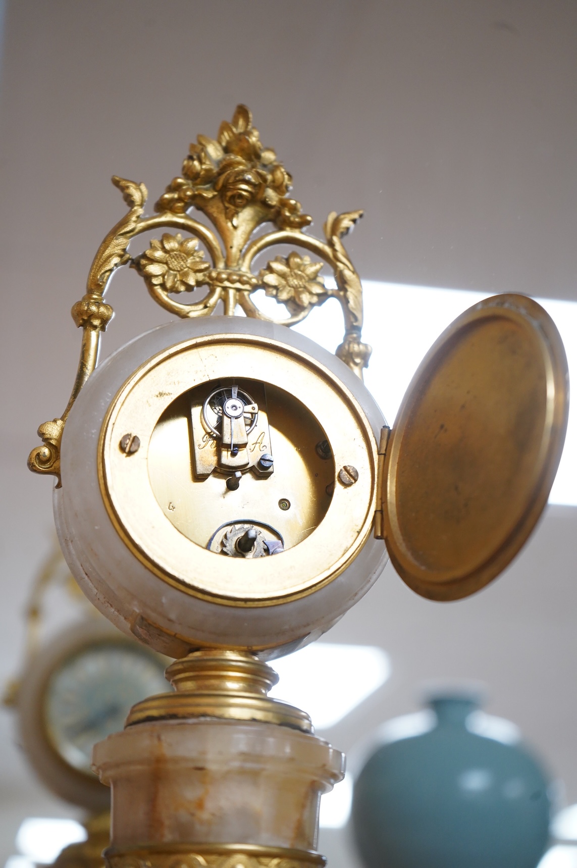A late 19th century French ormolu and alabaster timepiece with painted dial and key, 24cm high